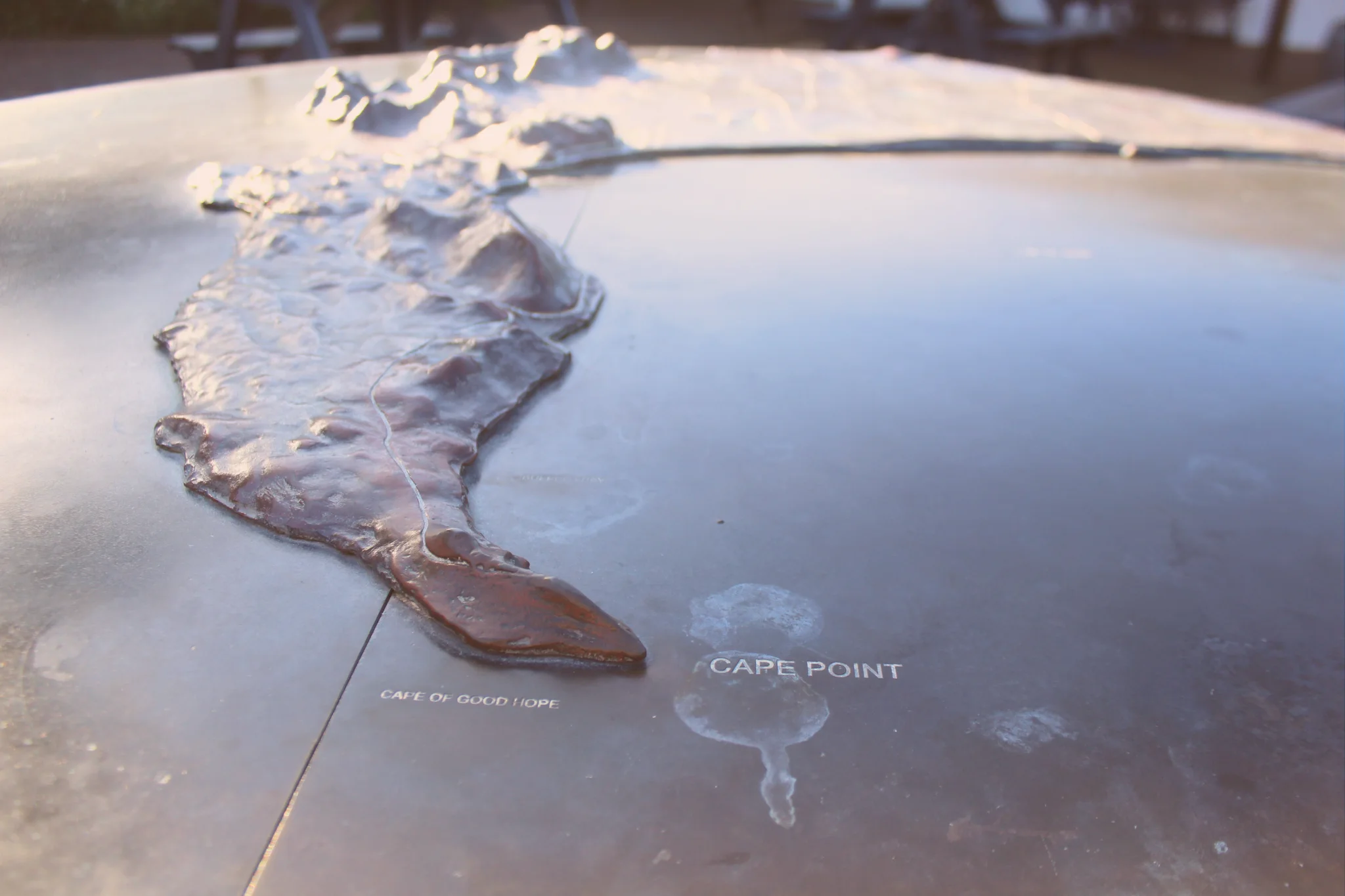 A raised metal relief map at Cape Point shows the Cape Peninsula’s mountain ridges, with labels for Cape Point and the Cape of Good Hope.